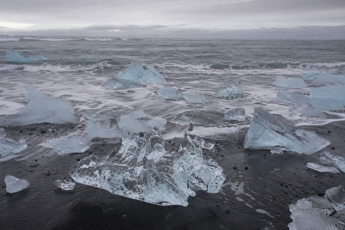 Chunks of ice resting on the black sand at Diamond Beach by Jökulsárlón lagoon