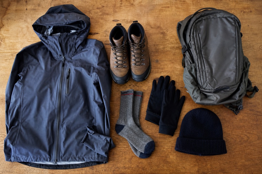 Flatlay of cold-weather travel gear for an Iceland packing list