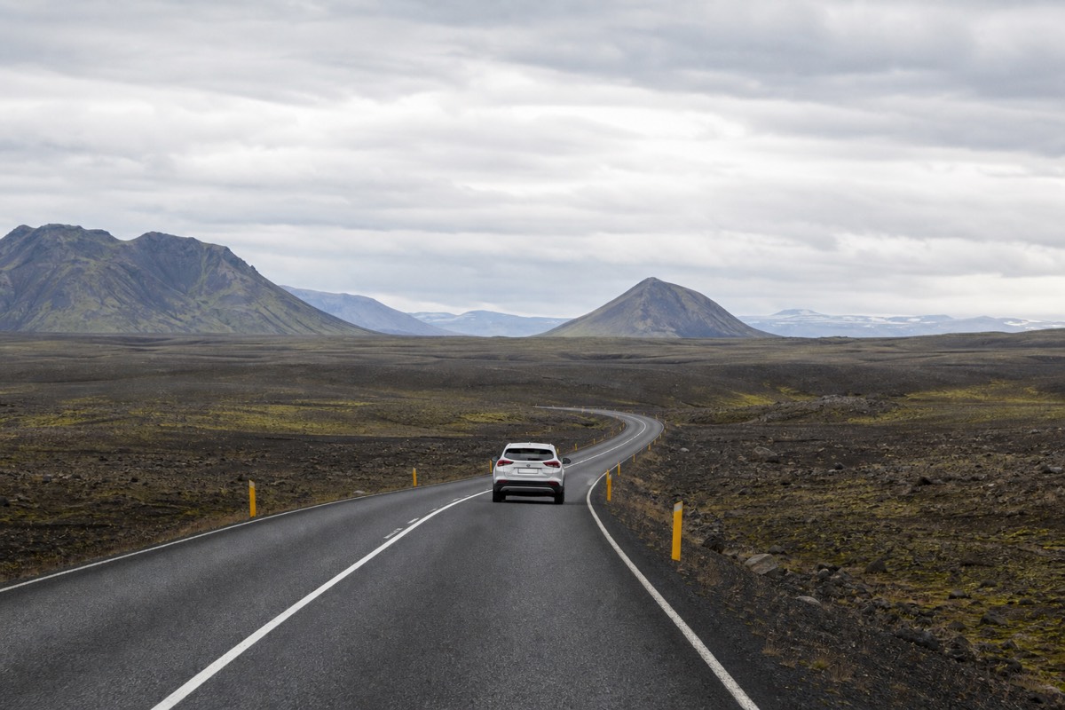 A rental car driving Iceland's Ring Road, a self-drive option in Iceland travel costs