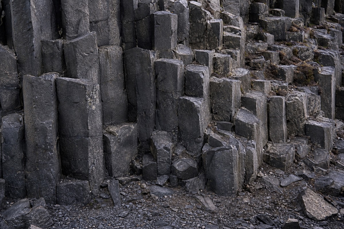 Basalt columns rise along the Icelandic coast, scenery passed while considering the cost of a trip to Iceland